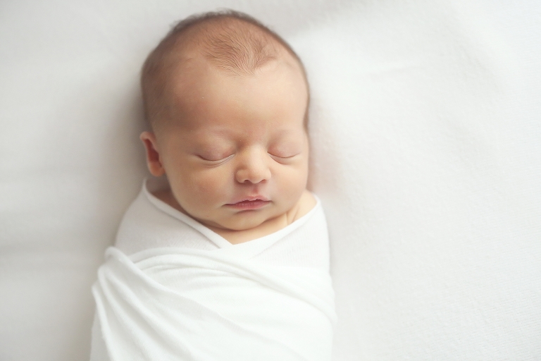 newborn photographer baby white cloth sleeping